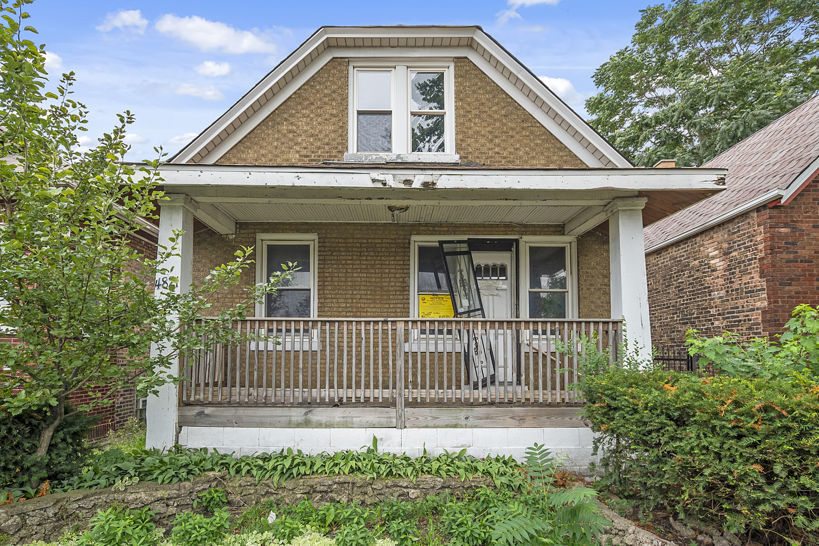 4821 West Hirsch Street Chicago, IL 60651 - Photo 3 of 23 a front view of a house with a garden