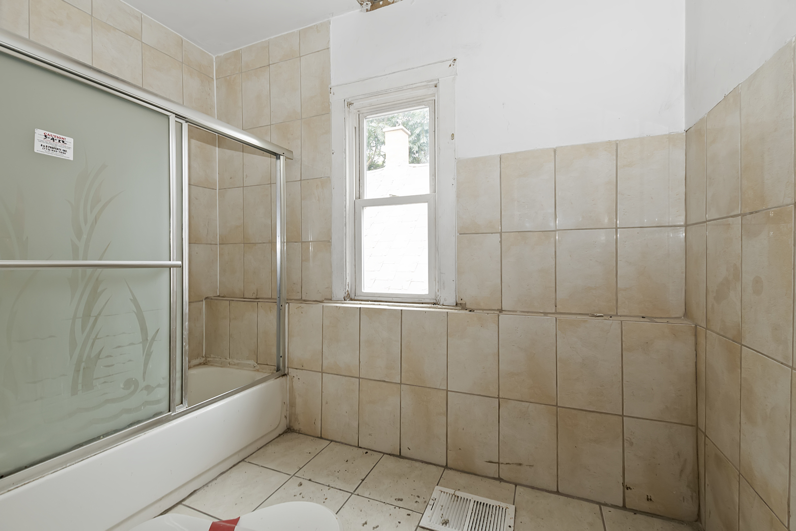 4821 West Hirsch Street Chicago, IL 60651 - Photo 9 of 23 a bathroom with a bathtub and shower