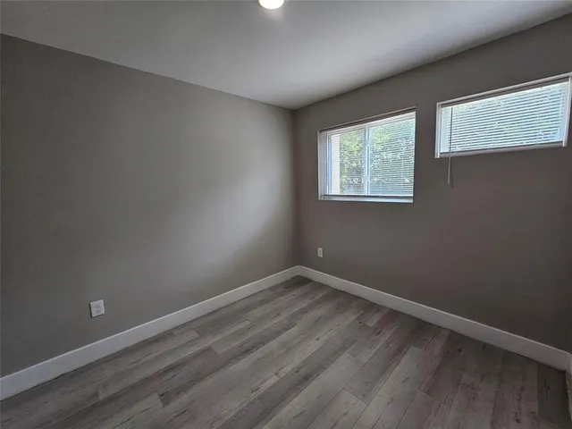 a view of an empty room with closet area