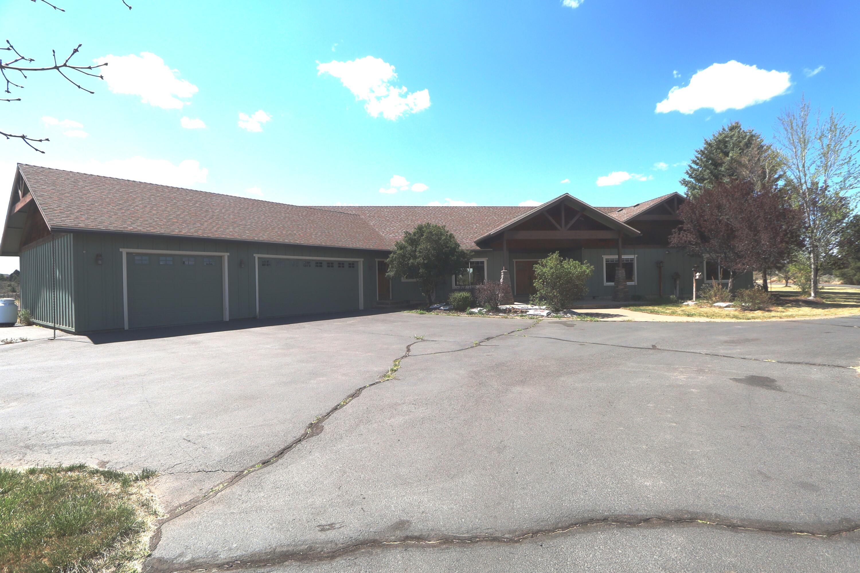 21491 Bear Creek Road Bend, OR 97701 - Photo 1 of 45 a view of the house with a yard and covered with snow
