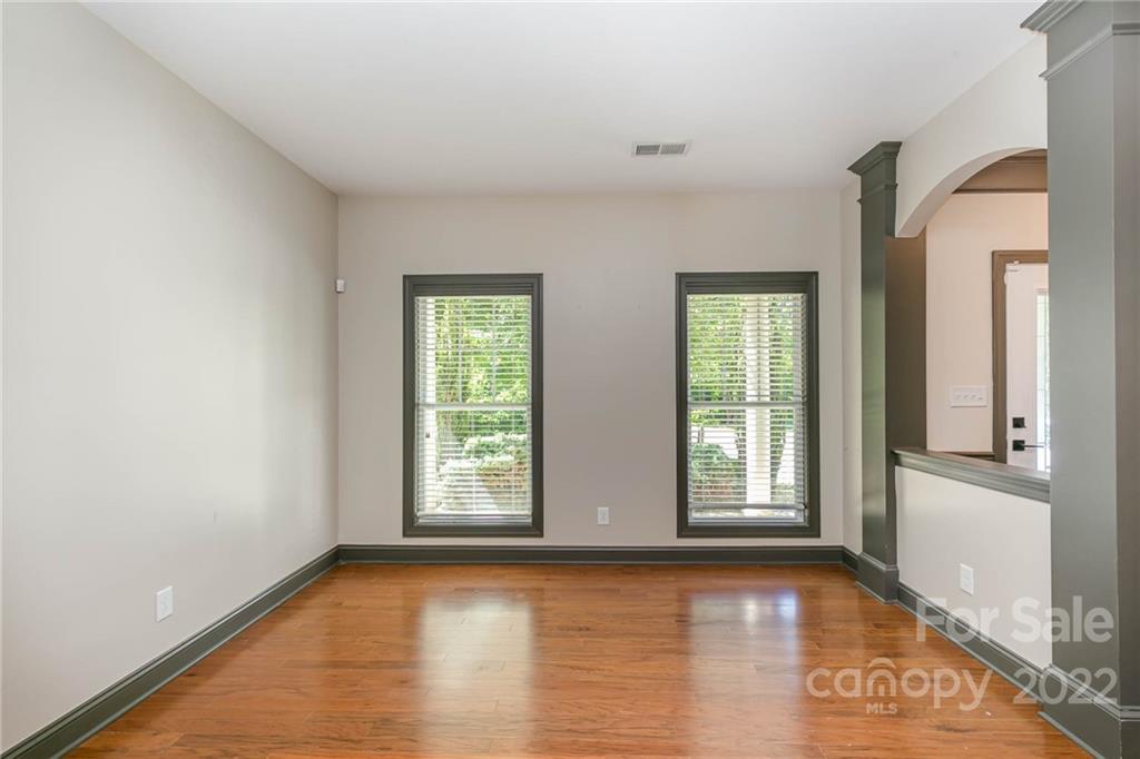 1000 Ridgehaven Road Waxhaw, NC 28173 - Photo 12 of 22 an empty room with wooden floor and windows