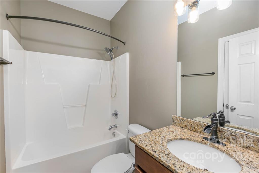 1000 Ridgehaven Road Waxhaw, NC 28173 - Photo 17 of 22 a bathroom with a granite countertop sink a toilet and shower