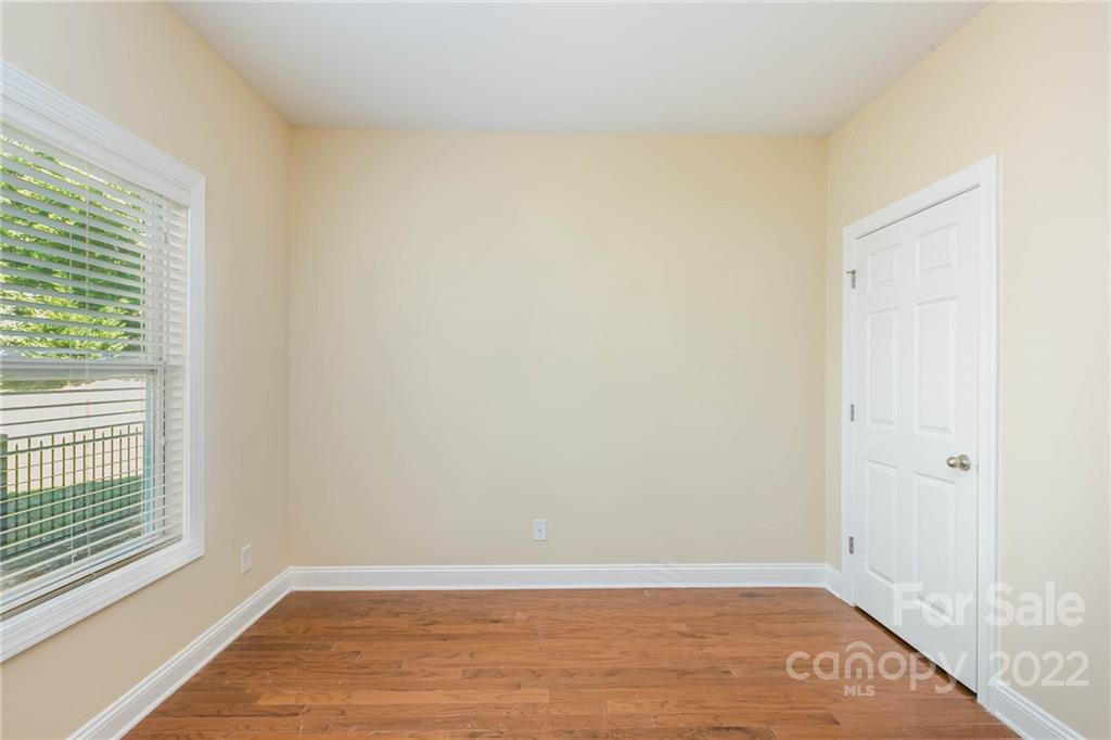 1000 Ridgehaven Road Waxhaw, NC 28173 - Photo 18 of 22 an empty room with wooden floor and windows