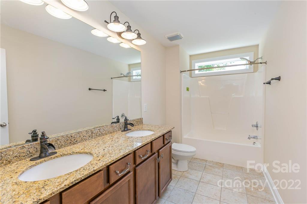 1000 Ridgehaven Road Waxhaw, NC 28173 - Photo 20 of 22 a bathroom with a granite countertop sink a toilet and shower