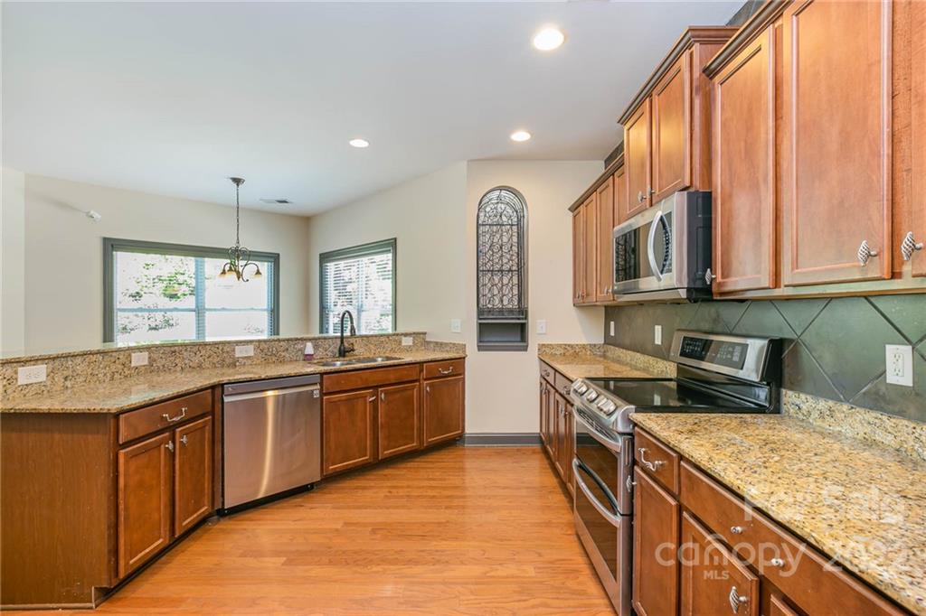 1000 Ridgehaven Road Waxhaw, NC 28173 - Photo 4 of 22 a large kitchen with stainless steel appliances granite countertop a lot of counter space and a sink