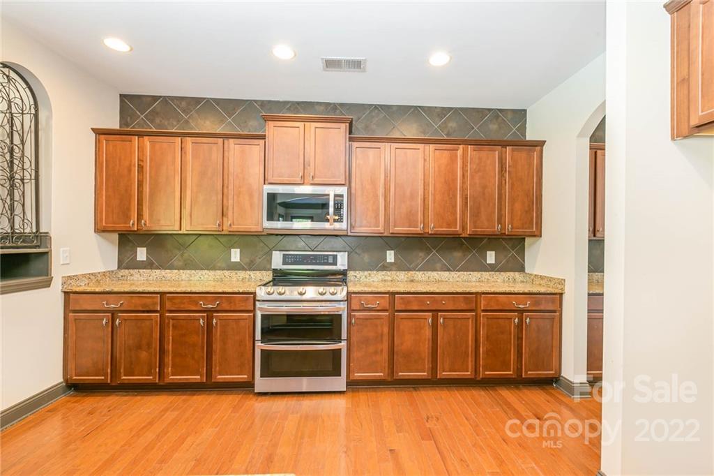 1000 Ridgehaven Road Waxhaw, NC 28173 - Photo 9 of 22 a kitchen with stainless steel appliances granite countertop a stove a sink and a microwave