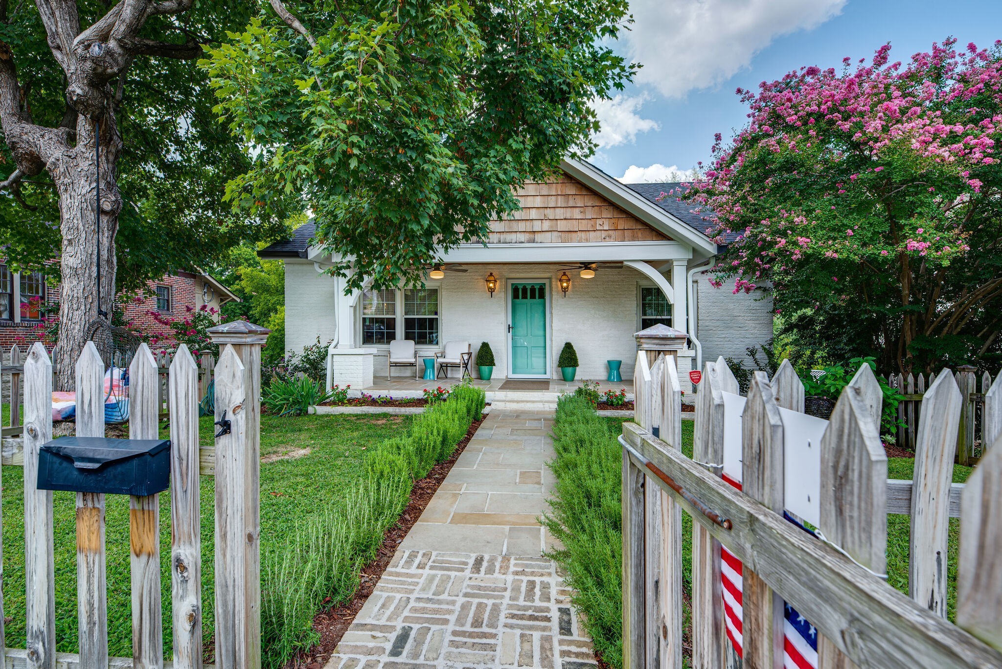 1715 Holly Street Nashville, TN 37206 - Photo 1 of 54 a front view of a house with a yard and potted plants