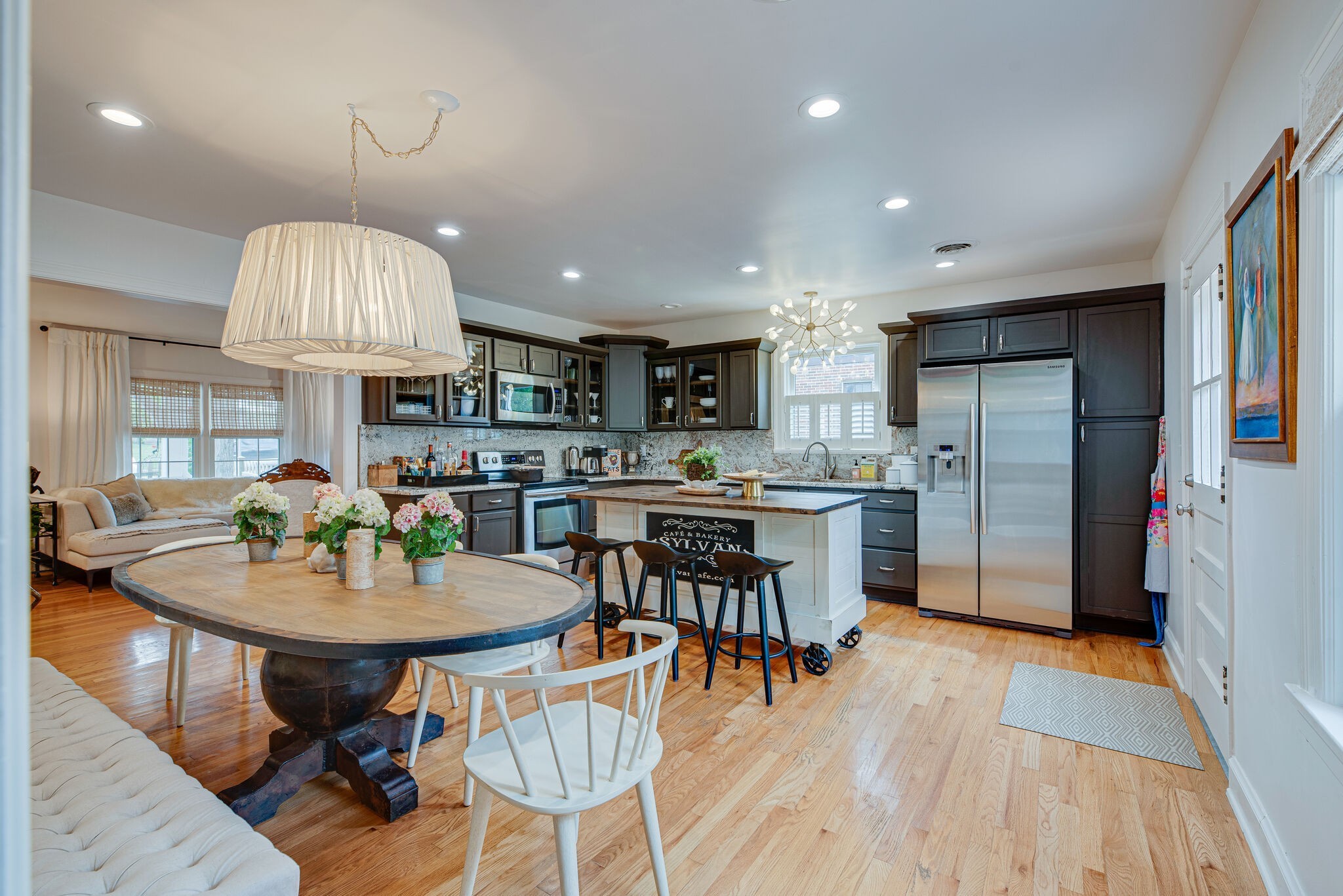 1715 Holly Street Nashville, TN 37206 - Photo 12 of 54 a kitchen with stainless steel appliances granite countertop a stove a refrigerator a kitchen island a dining table and chairs with wooden floor