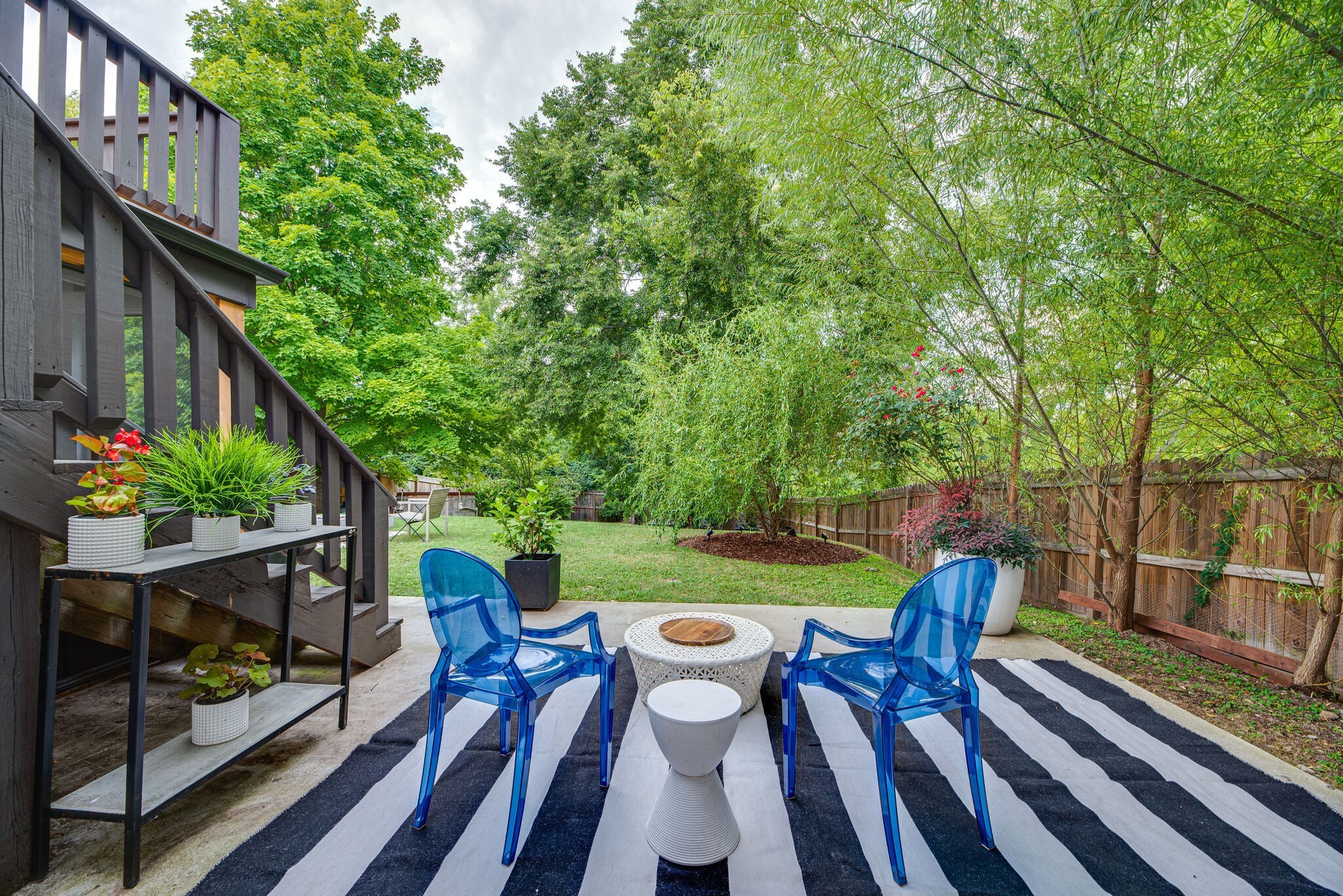 1715 Holly Street Nashville, TN 37206 - Photo 42 of 54 a view of a patio with table and chairs potted plants with wooden floor and fence