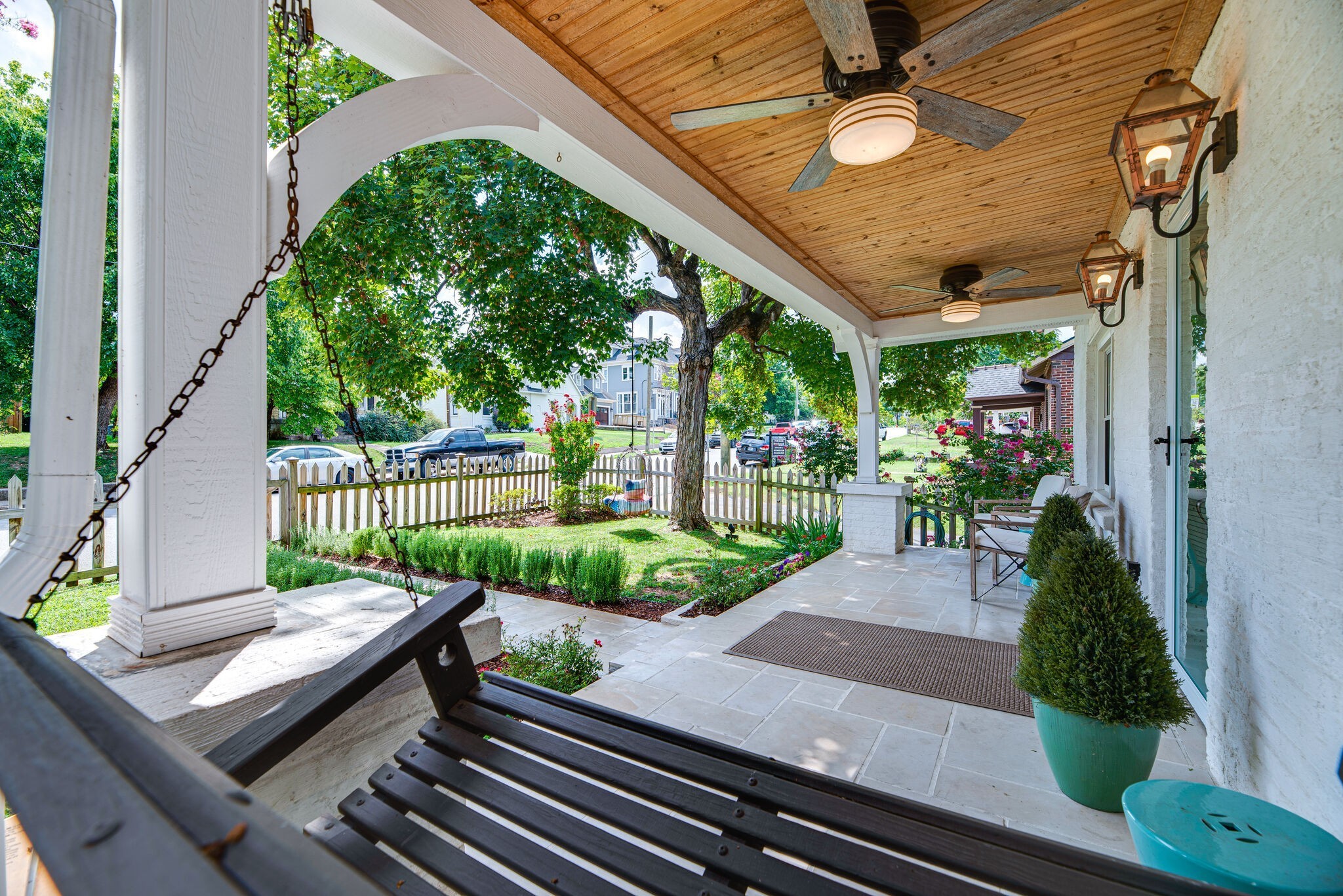 1715 Holly Street Nashville, TN 37206 - Photo 6 of 54 a view of a patio with couches table and chairs potted plants with wooden floor and fence