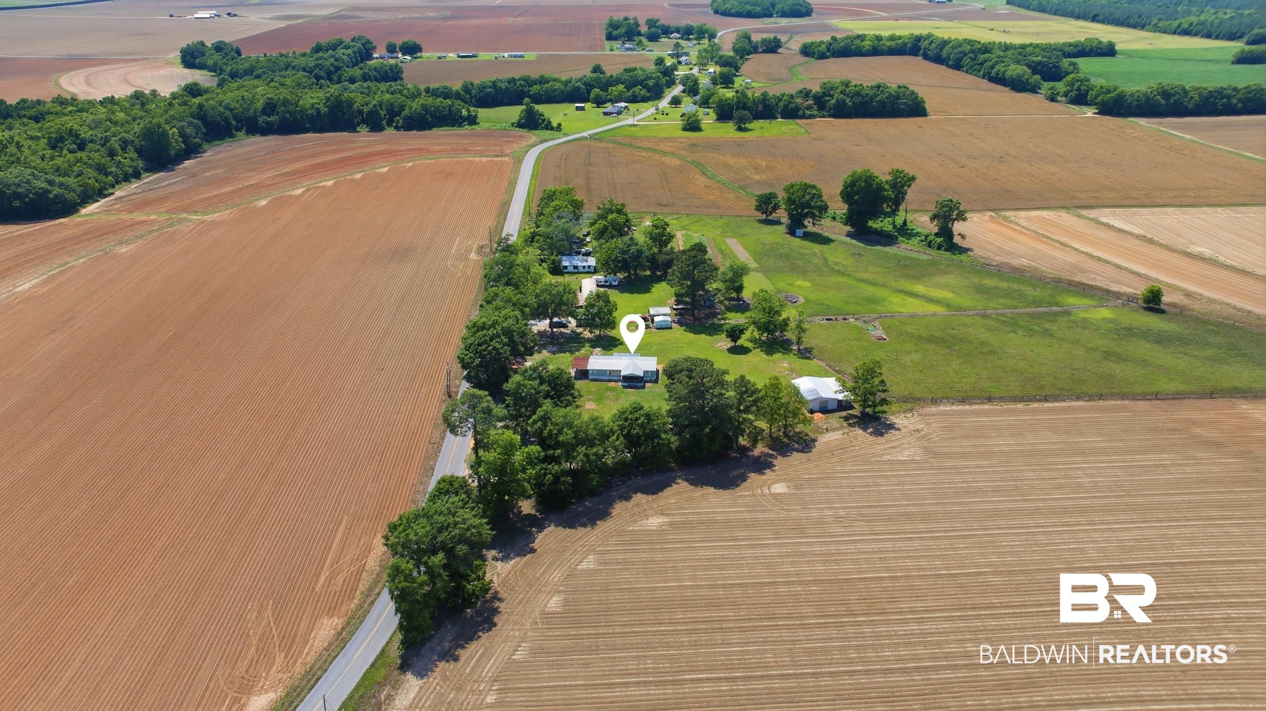 926 Tumbling Lane Atmore, AL 36502 - Photo 49 of 56 Expansive land parcel featuring cultivated fields and scattered trees