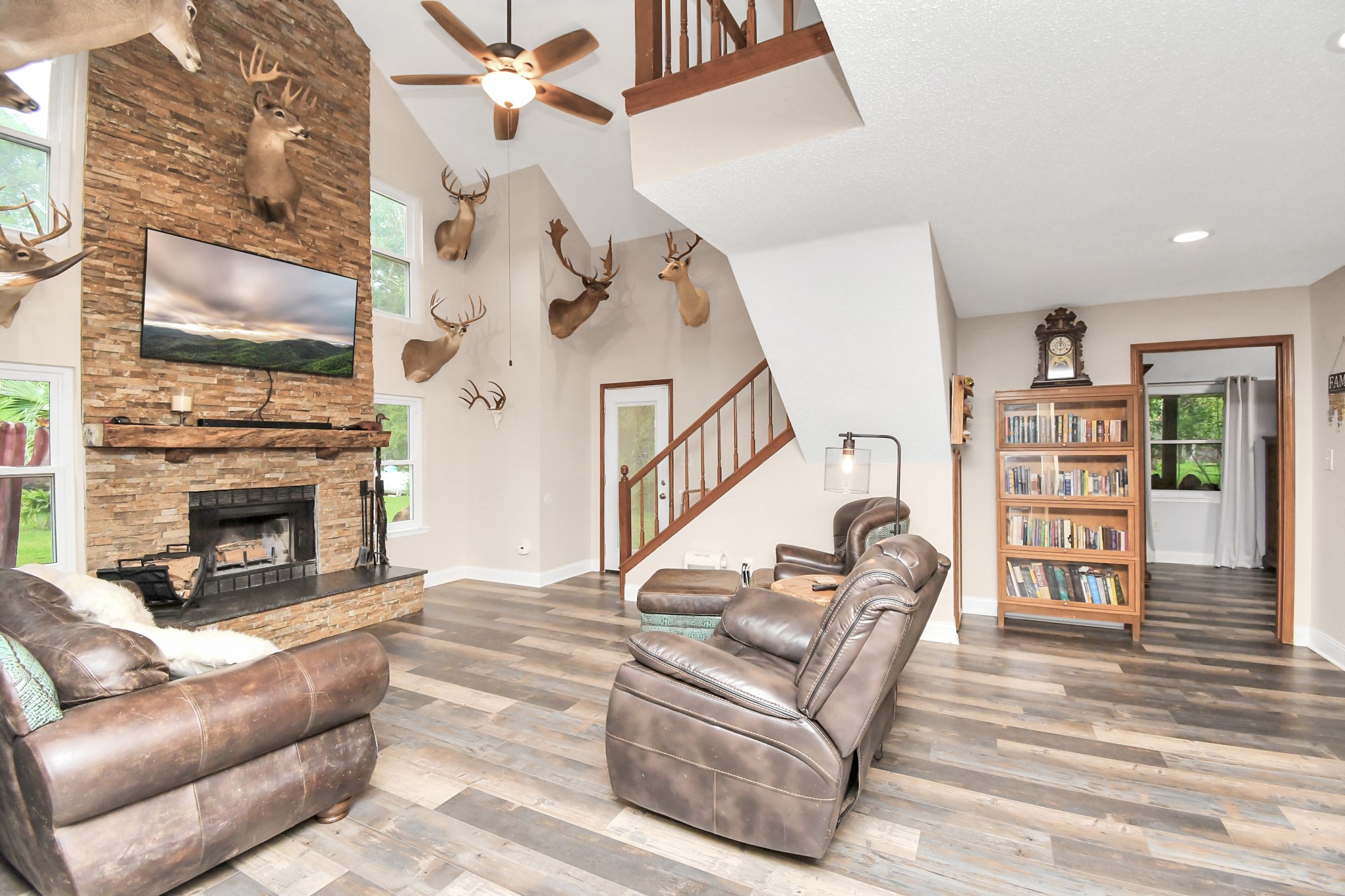 20202 Deer Run Road Damon, TX 77430 - Photo 11 of 45 a living room with furniture a fireplace and a flat screen tv
