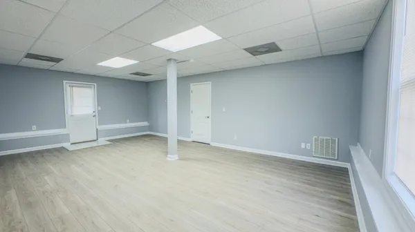 a view of a room with wooden floor