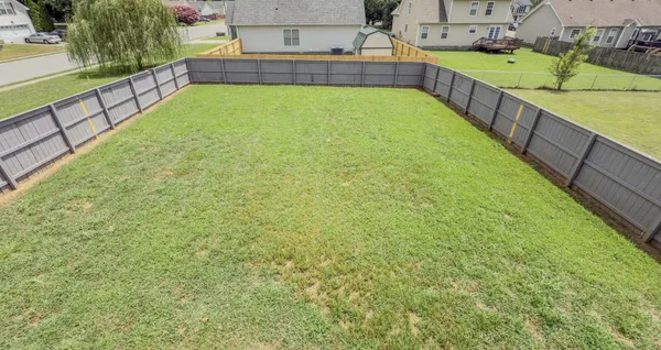 a view of a house with backyard and porch