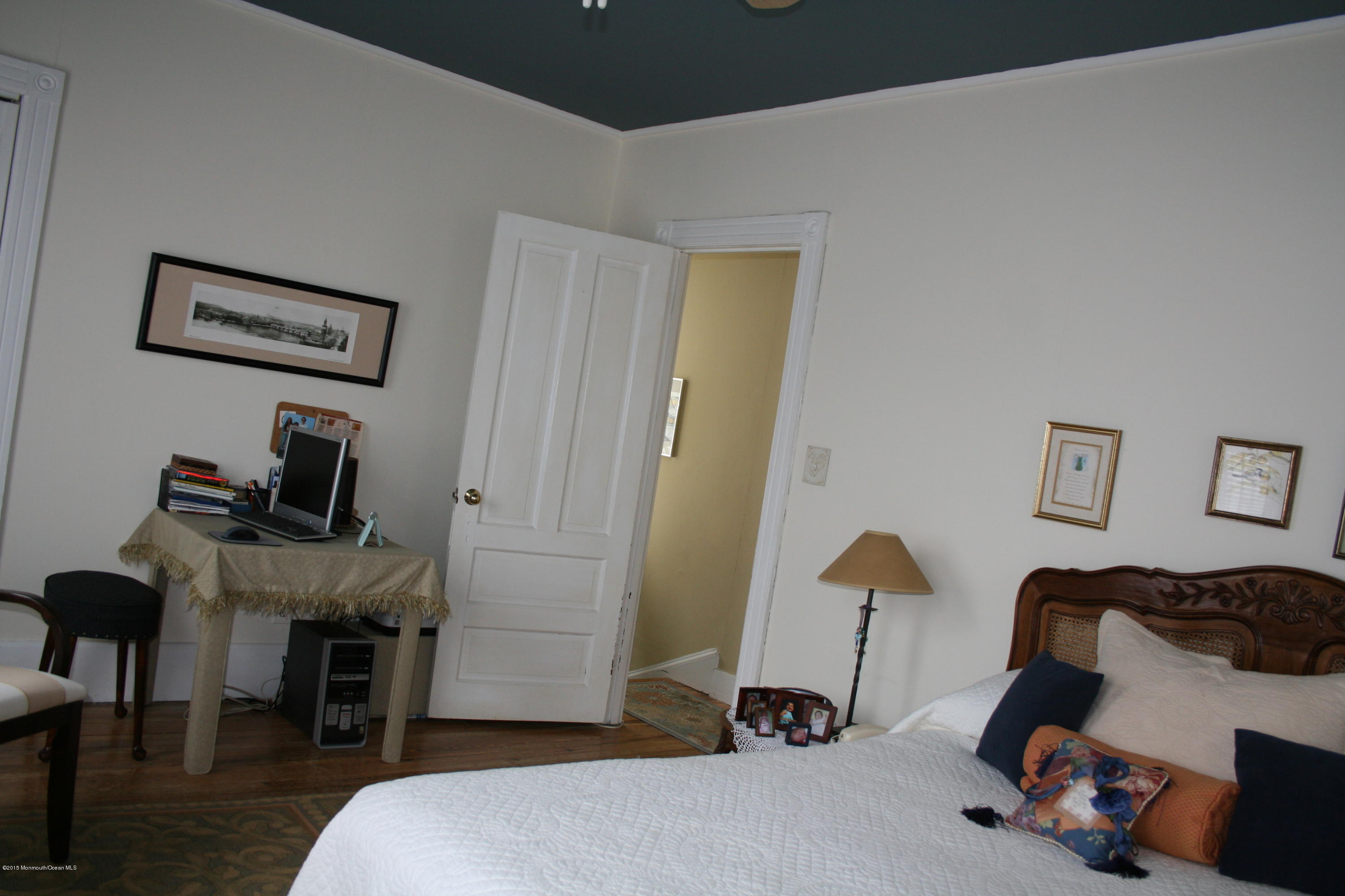 42 Spring Street Red Bank, NJ 07701 - Photo 15 of 24 a bedroom with a bed and a mirror