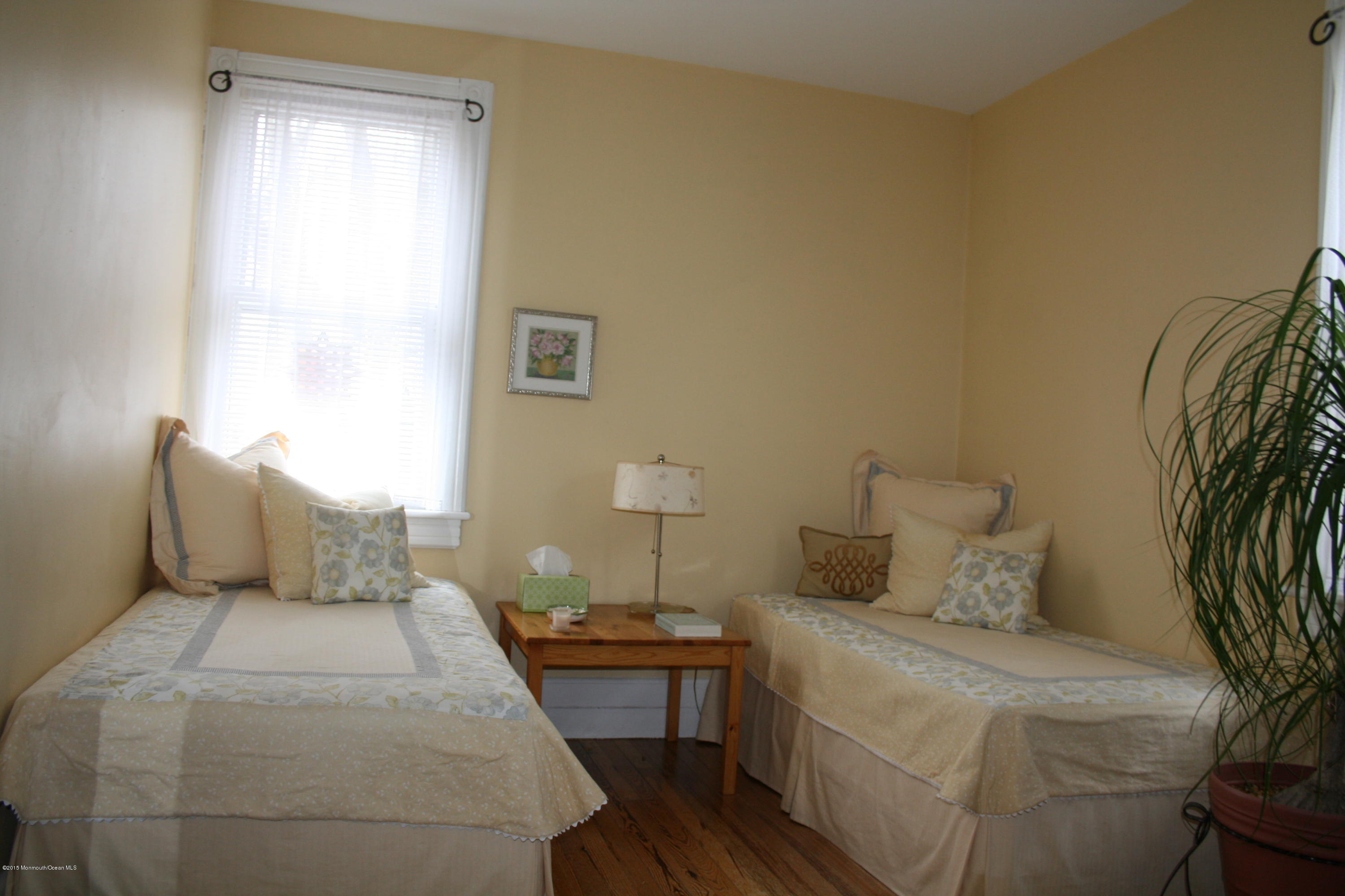 42 Spring Street Red Bank, NJ 07701 - Photo 19 of 24 a bedroom with a bed and wooden floor