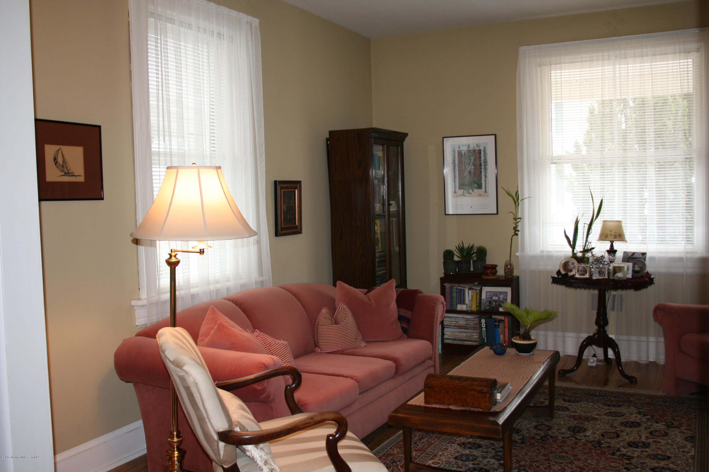 42 Spring Street Red Bank, NJ 07701 - Photo 6 of 24 a living room with furniture a lamp and a window
