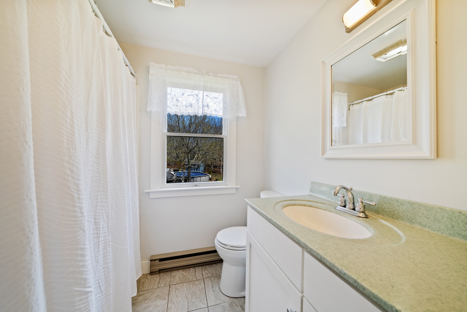 357 West Tisbury Road Edgartown, MA 02539 - Photo 12 of 33 a bathroom with a granite countertop sink a toilet and a mirror