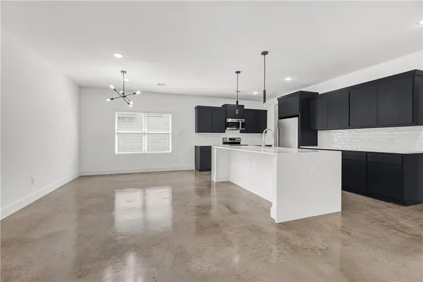 a view of a kitchen with microwave and cabinets