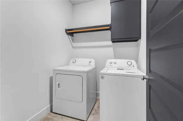 an empty room with ceiling fan and windows