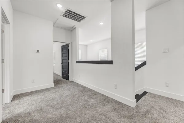 an empty room with a ceiling fan and a window