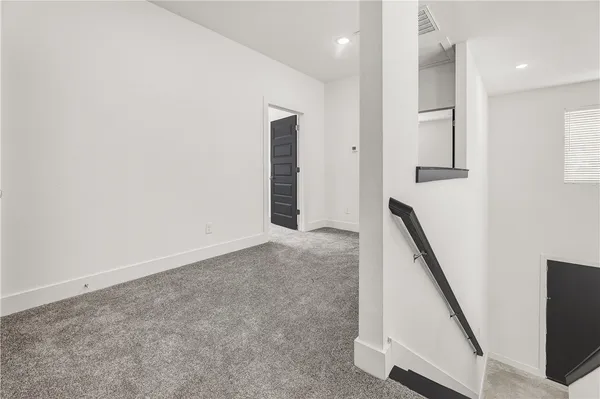 a bathroom with a granite countertop toilet sink and mirror