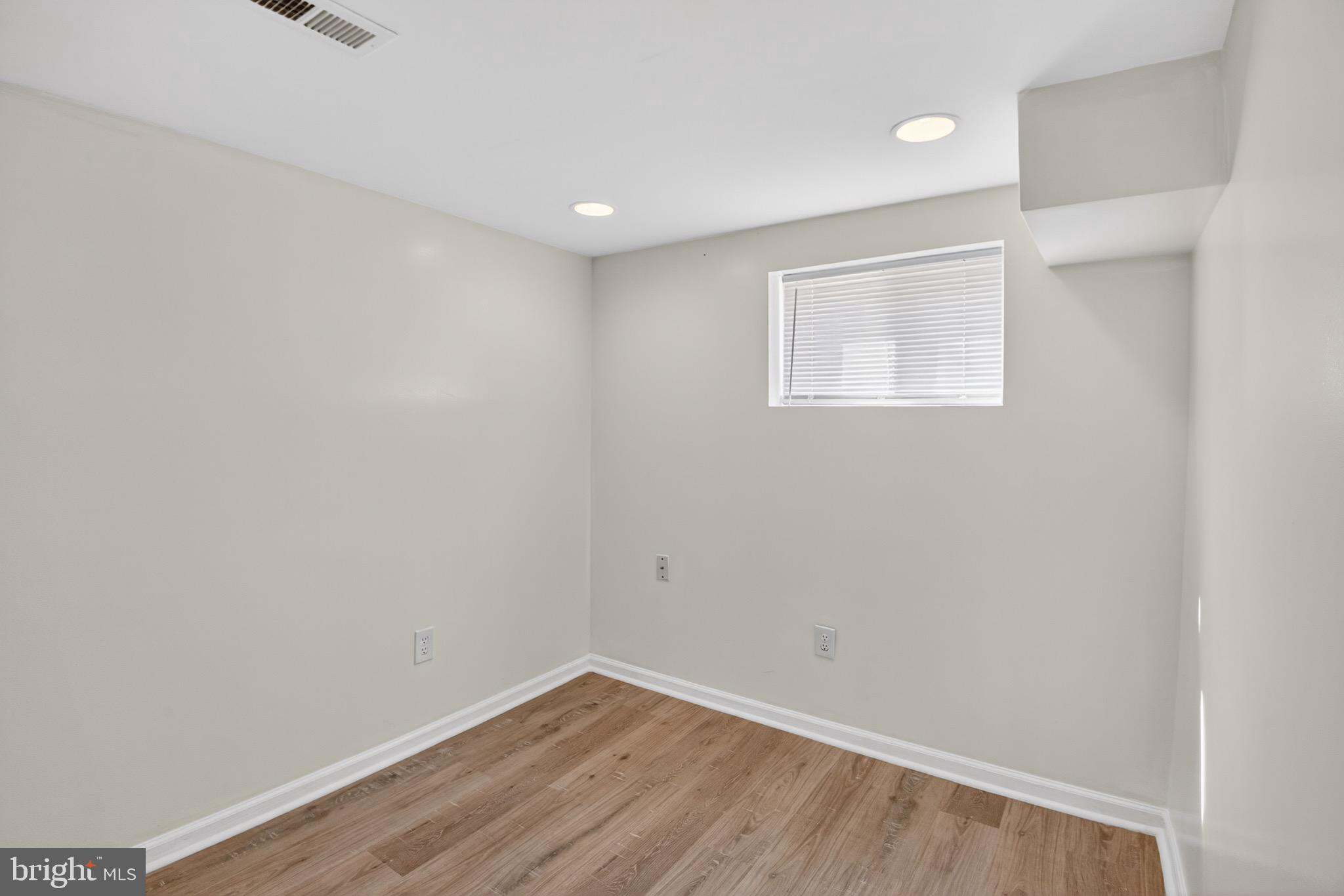 141 Uhland Terrace Northeast Washington, DC 20002 - Photo 13 of 16 a view of an empty room with wooden floor