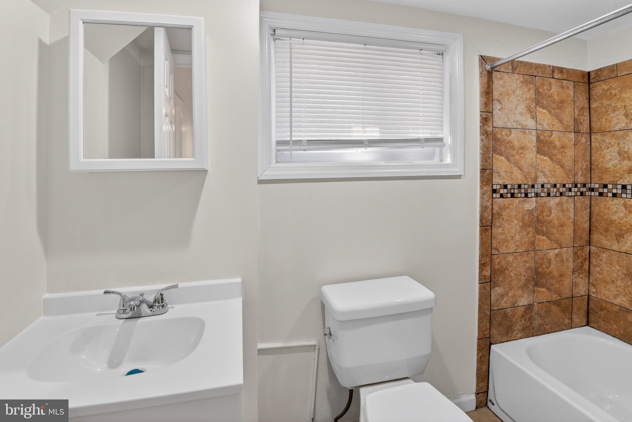 141 Uhland Terrace Northeast Washington, DC 20002 - Photo 15 of 16 a bathroom with a sink a toilet and shower