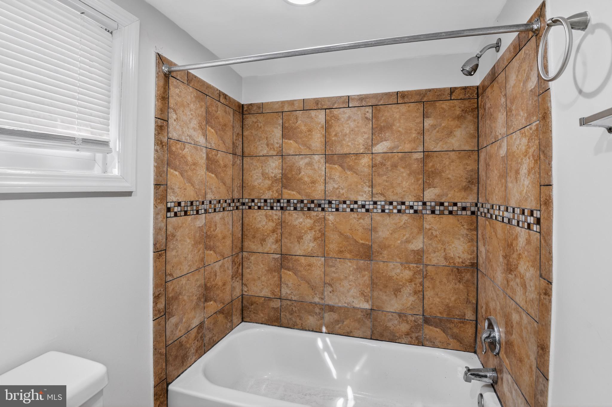 141 Uhland Terrace Northeast Washington, DC 20002 - Photo 16 of 16 a bathroom with a shower and a bathtub