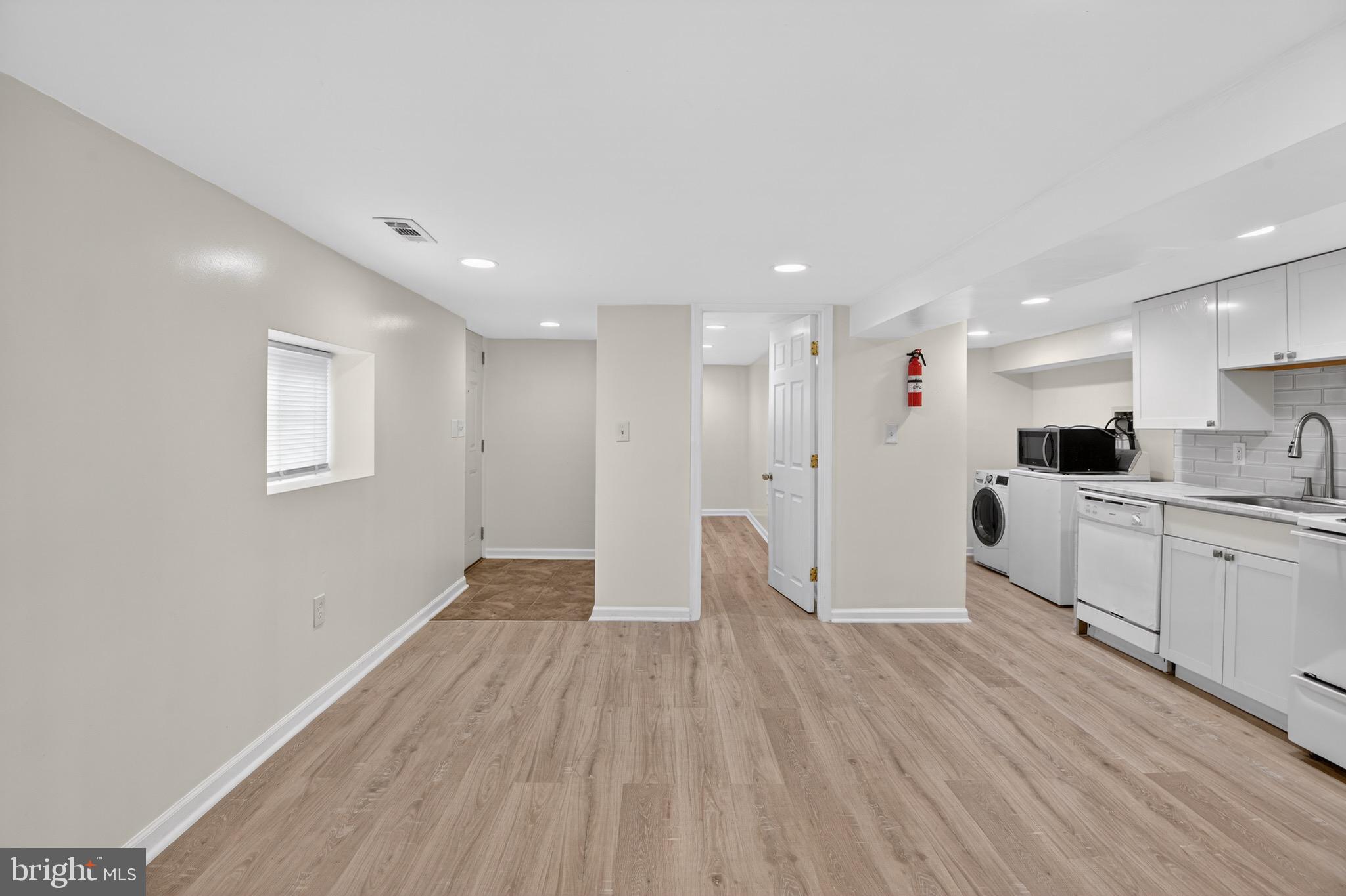 141 Uhland Terrace Northeast Washington, DC 20002 - Photo 5 of 16 a view of kitchen with a sink wooden floor and window