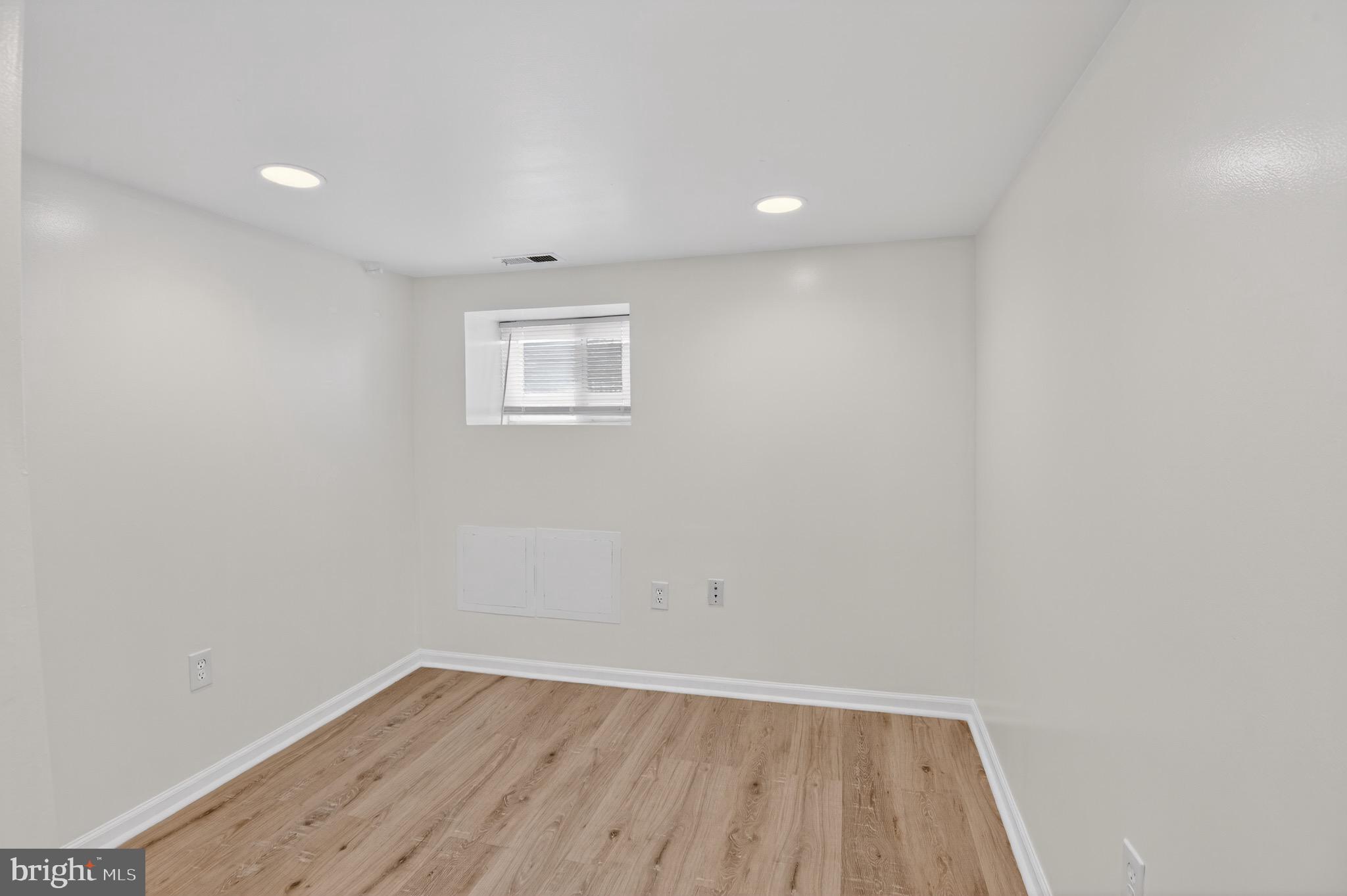 141 Uhland Terrace Northeast Washington, DC 20002 - Photo 10 of 16 an empty room with wooden floor and windows