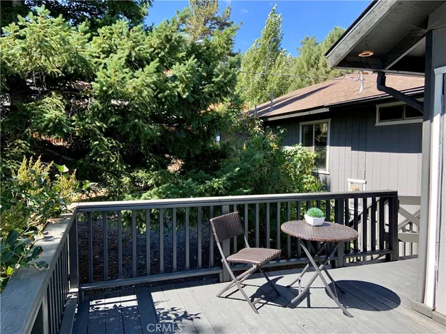 a view of a wooden deck with furniture