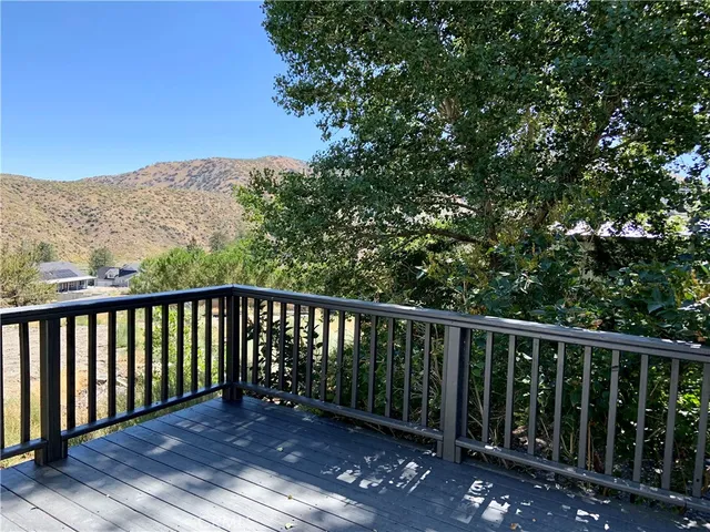 a balcony with wooden floor and fence