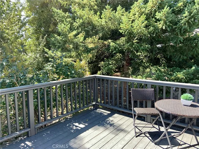 a view of a balcony with wooden floor