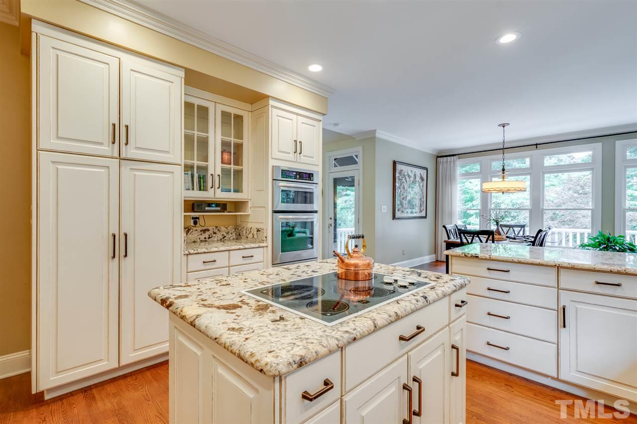 7604 Kelmscot Way Raleigh, NC 27615 - Photo 14 of 30 a kitchen with stainless steel appliances granite countertop a sink and a wooden cabinets