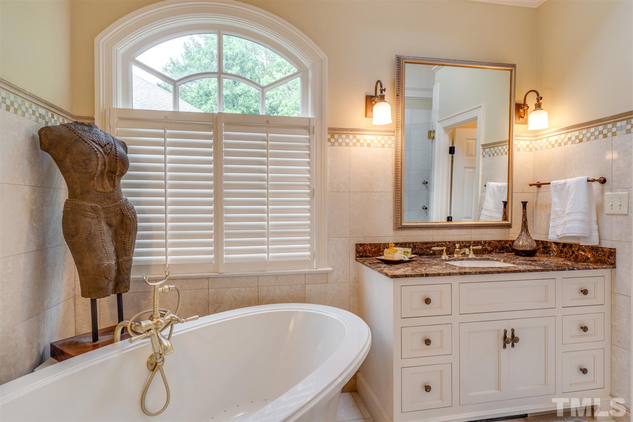 7604 Kelmscot Way Raleigh, NC 27615 - Photo 19 of 30 a bathroom with a granite countertop sink and a mirror
