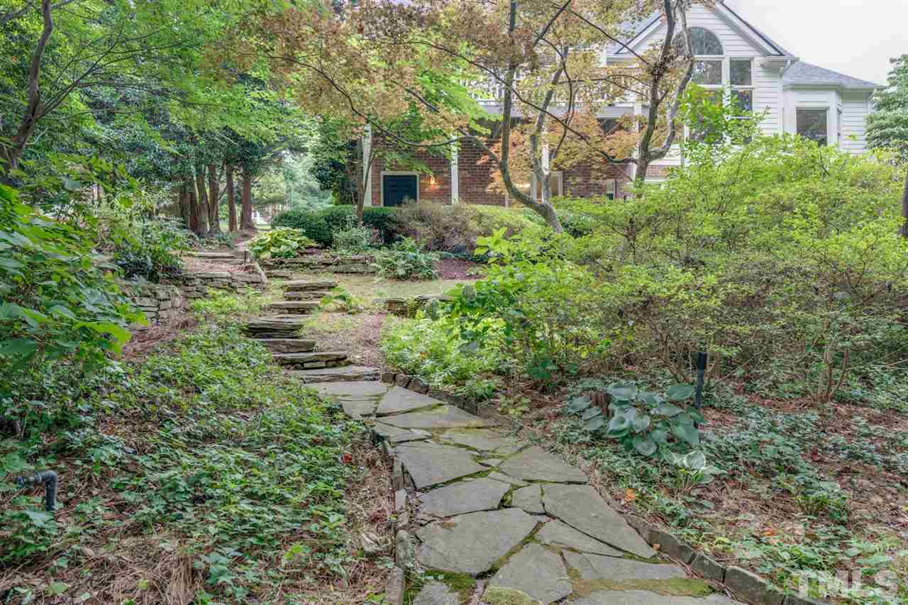 7604 Kelmscot Way Raleigh, NC 27615 - Photo 28 of 30 a view of a yard with plants and large trees