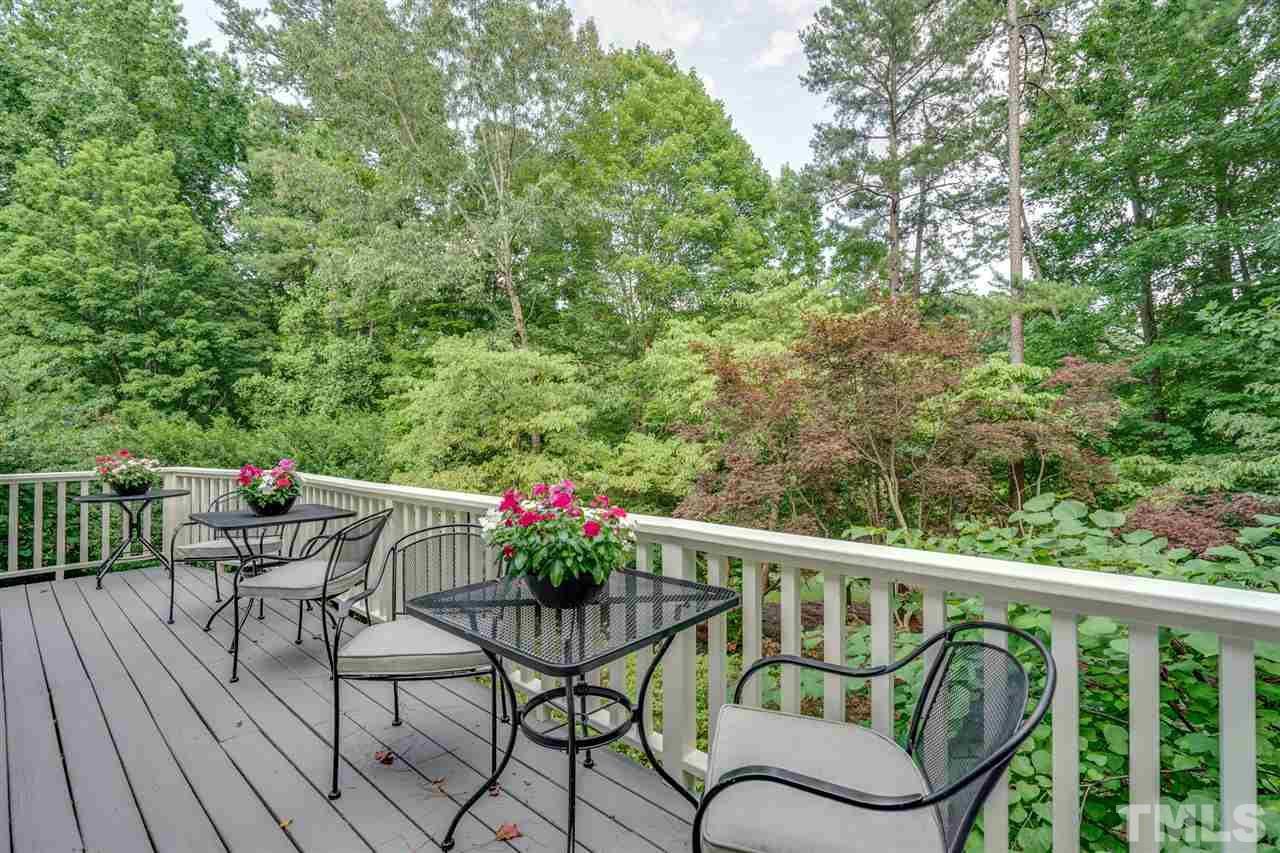 7604 Kelmscot Way Raleigh, NC 27615 - Photo 5 of 30 a balcony with wooden floor potted plants and outdoor seating
