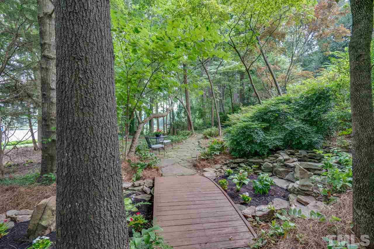 7604 Kelmscot Way Raleigh, NC 27615 - Photo 6 of 30 a view of a pathway with a tree