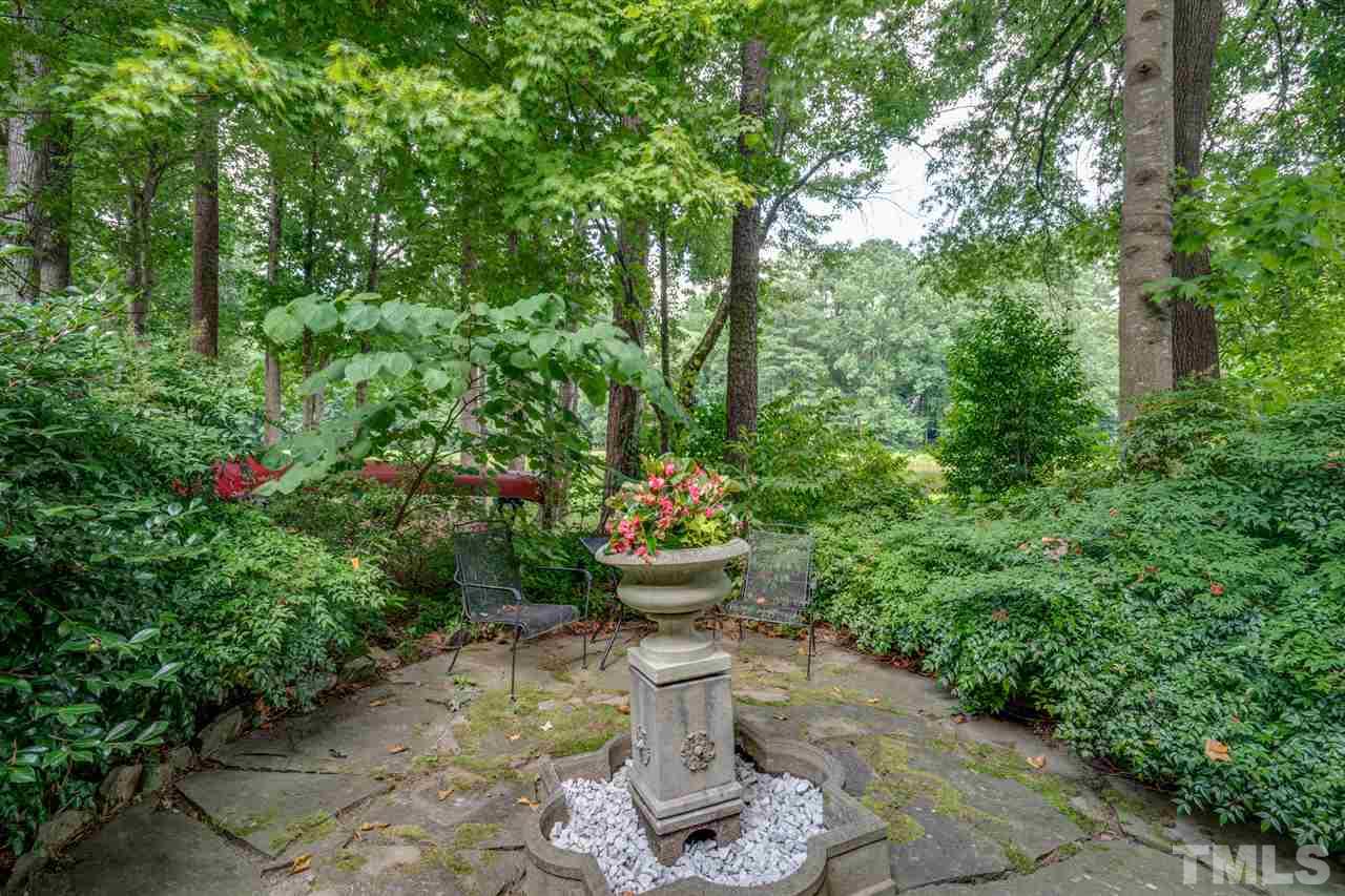 7604 Kelmscot Way Raleigh, NC 27615 - Photo 7 of 30 a view of a garden with fountain