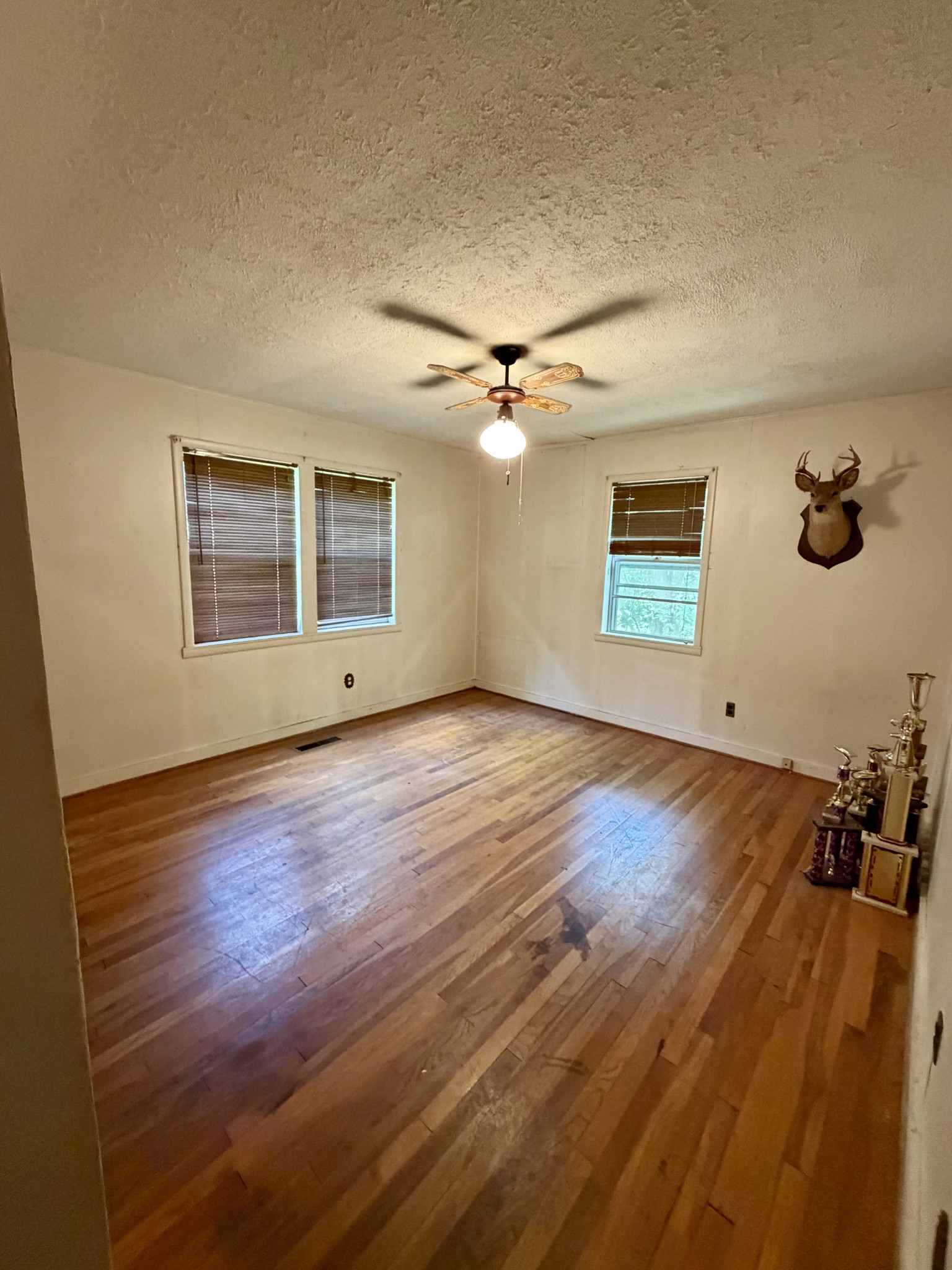 2115 Spring Hill Road Paris, TN 38242 - Photo 13 of 18 a view of an empty room with a window and wooden floor