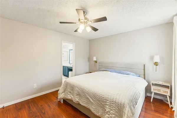 a bedroom with a bed and a ceiling fan