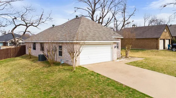 a view of a house with a yard and garage