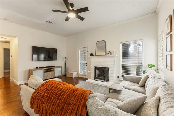 a living room with furniture a fireplace and a flat screen tv
