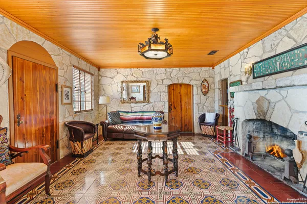 a living room with furniture a rug and a table