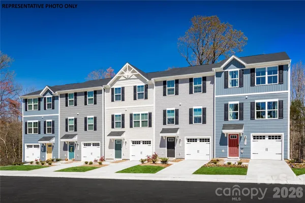 a front view of a building with lot of cars