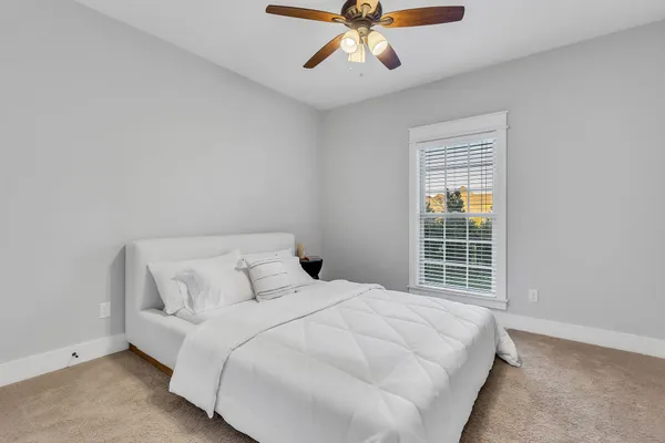 a bedroom with a large bed and a window