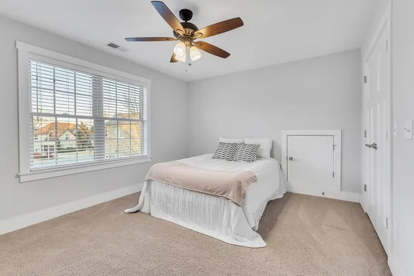 a spacious bedroom with a bed and a large window