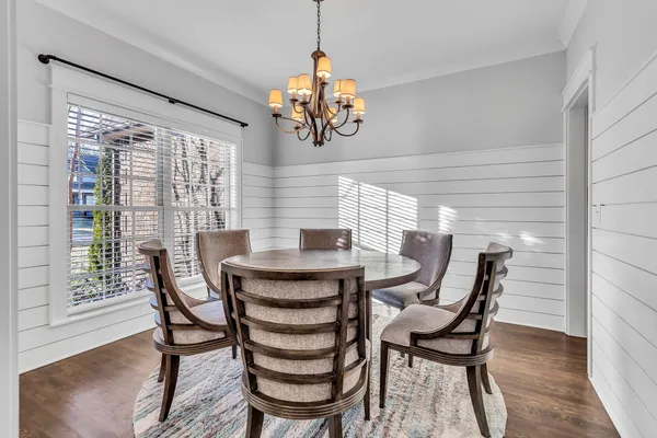 a dining room with furniture and window