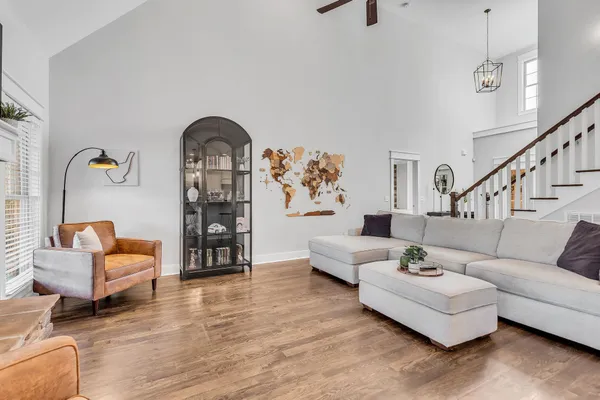 a living room with furniture and wooden floor